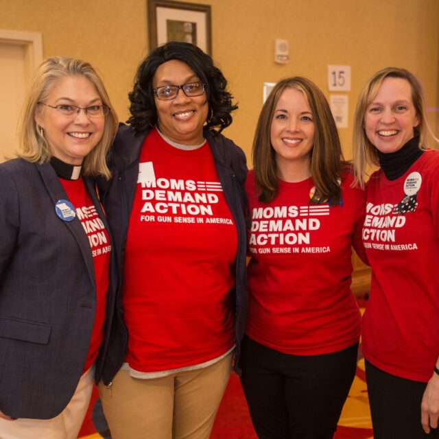 4 Moms Demand Action volunteers wear red t-shirts with 