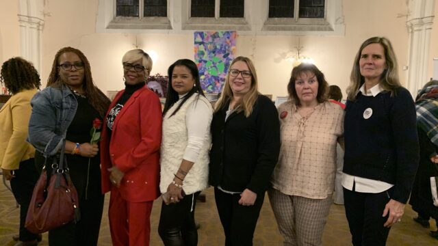 A group of six volunteers and survivors of gun violence pose for a photo at an event in Philadelphia
