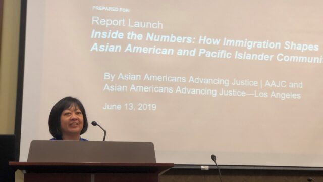 Marita Etcubañez of Asian Americans Advancing Justice speaks at a podium at an event