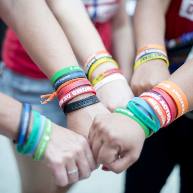A group of volunteers all wear bracelets for Moms Demand Action