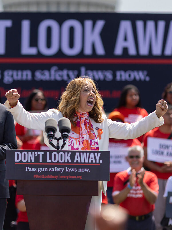 Lucy McBath stands at a podium with the words 