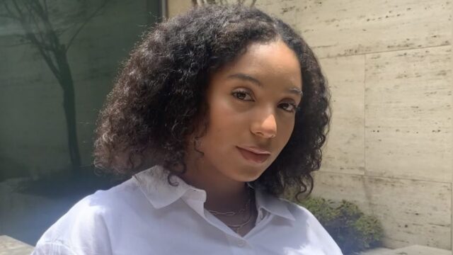 Volunteer leader Ade stands outdoors