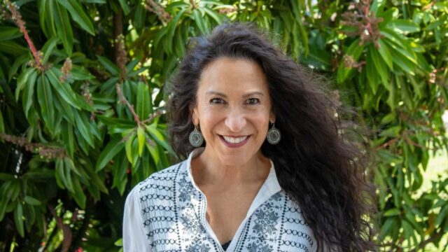 Cindy Montoya smiles while standing outdoors