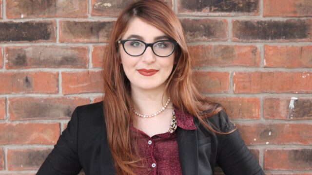 Mariam El-Haj stands in front of a brick wall