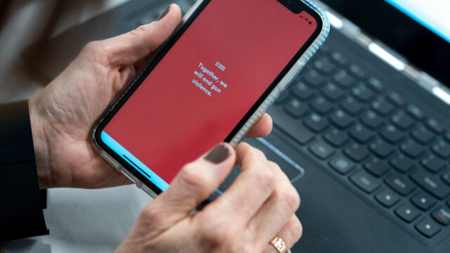 A close-up of a smartphone screen with a red background, opened to the 