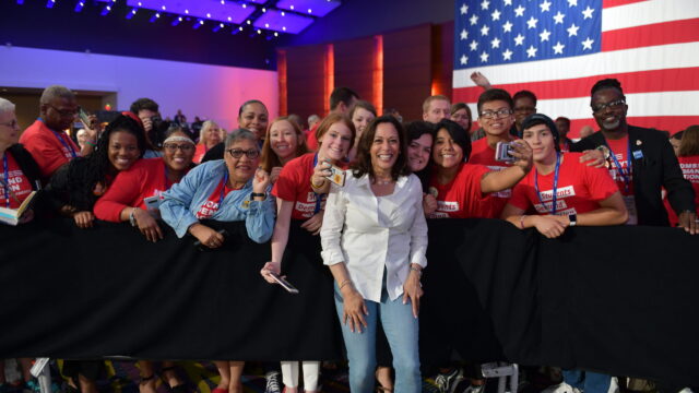 Kamala Harris smiles with a group of Moms Demand Action and Students Demand Action volunteers at the Presidential Gun Sense Forum
