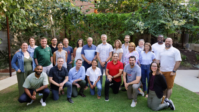 Members of the Everytown Veterans Advisory Council pose in a semi-circle for a photo.