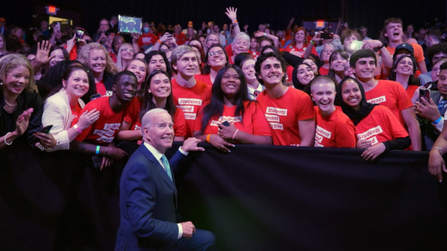 President Biden poses for a photo with Students Demand Action volunteers