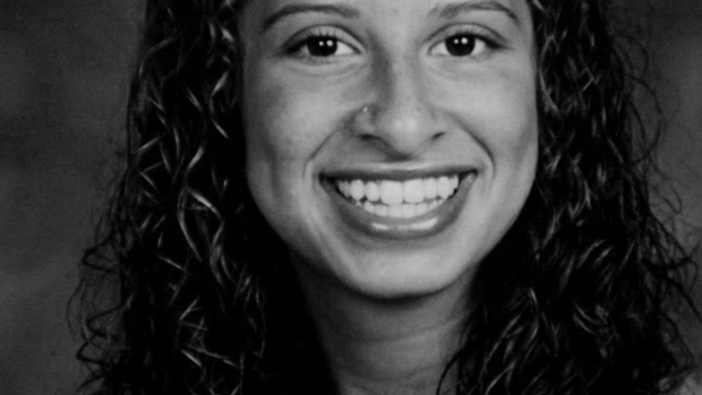 An image of Darien Richardson, a 25-year-old woman. She is smiling at the camera and has long, curly hair.