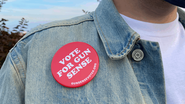 A person wearing a vote for gun sense pin