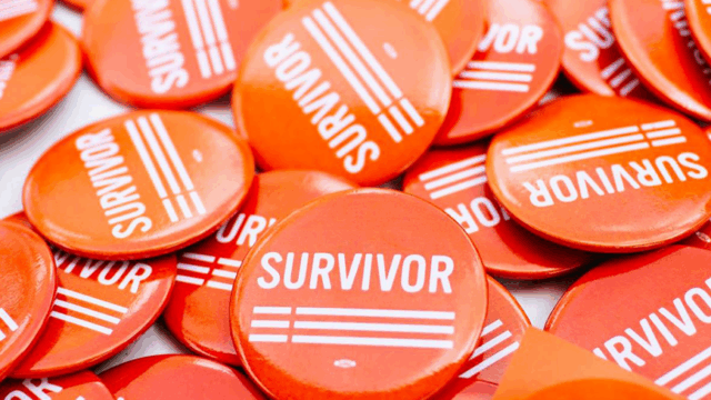 A pile of pins with the word, 'survivor' on all of them