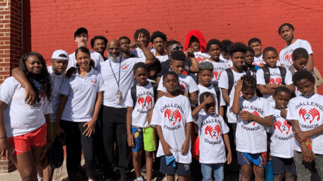 Terry ‘Uncle T’ Williams of Challenge 2 Change poses for a group photo with about 20 young people
